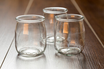 empty glasses for yogurt, on a wooden background