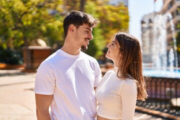 Fototapeta premium Mand and woman couple hugging each other at park