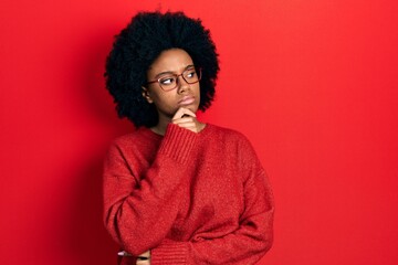Young african american woman wearing casual clothes and glasses thinking concentrated about doubt...