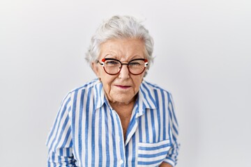 Senior woman with grey hair standing over white background with hand on stomach because nausea,...