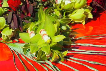Green Cymbidium Orchid flowers, Leucadendron Jester, Banksia red. Beautiful bouquet of exotic...