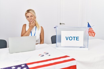 Young caucasian woman at america political campaign election touching mouth with hand with painful expression because of toothache or dental illness on teeth. dentist concept.