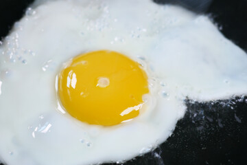 Fried eggs in the pan close up ,