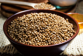 Coriander grains in a ceramic bowl.