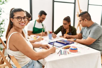 Group of draw students sitting on the table drawing at art studio.