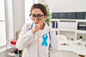 Young brunette doctor woman wearing stethoscope at the clinic feeling unwell and coughing as symptom for cold or bronchitis. health care concept.