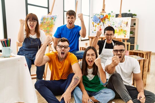 Group of people sitting at art studio annoyed and frustrated shouting with anger, yelling crazy with anger and hand raised