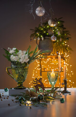 christmas still life with branch of fir, candles and lights