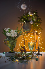 christmas still life with branch of fir, candles and lights