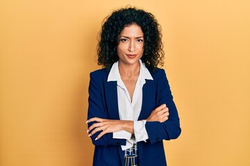 Young latin girl wearing business clothes skeptic and nervous, disapproving expression on face with...