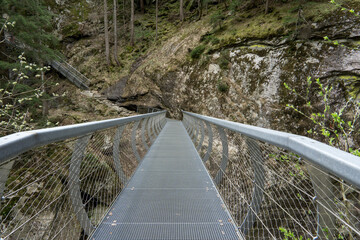 bridge and way as a metal construction through a canyon
