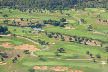 Fototapeta na wymiar aerial view of golf area at Las Palmas, Mallorca, Spain with green meadow in sunshine.