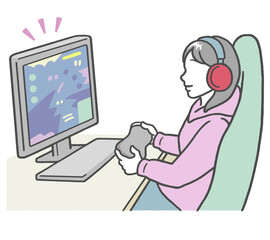 パソコンでゲームをする、ヘッドフォンを付けた若い女性