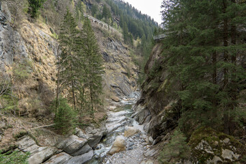 canyon of passeier surrounded by mountains with rocks and trees 