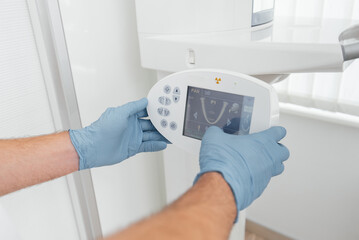 A young man has a computed tomography of the jaw, a circular snapshot of the jaw in modern dentistry. Prevention of caries, prosthetics and dental treatment. Radiology, panoramic scanner.