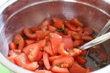 Traditional tomatoe salad in an steel bowl in the spanish kitchen.