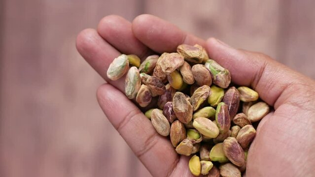 close up of pistachios nut on hand 