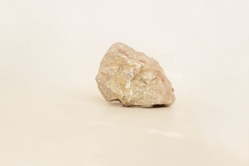 Light stone podium for products, cosmetics, cream or perfumes on beige background.