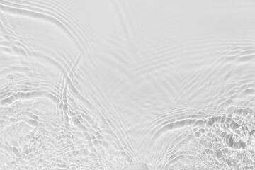 Waves on transparent water surface, gray abstract background.