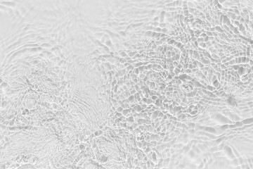 Waves on transparent water surface, gray abstract background.