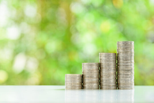 Cash Flow Growth From Long-term Sustainable Investments, Financial Concept : Four Increasing-height Coin Stacks On A Table With A Green Bokeh Background, Depicting Saving Money For Retirement, Etc