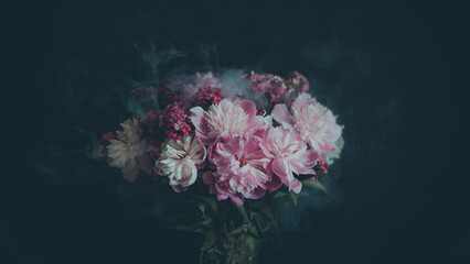 Bouquet of pink flowers in smoke