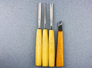 Cutters for woodcarving. Professional steel forged chisels with wooden handles for handmade miniature woodcarving.