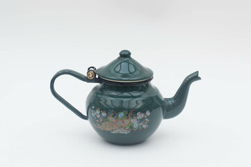 Mid-century modern blue enameled kettle with peacock pattern isolated