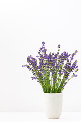 Naklejka na ściany i meble Beautiful summer lavender flowers in a vase, part of a home interior