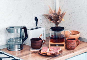Interior of the kitchen in the morning. Breakfast is being prepared.