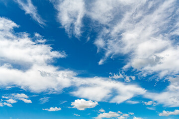 Naklejka na ściany i meble White cloud against the blue summer sky.