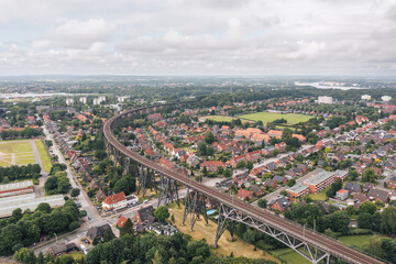 Aerial view on Rendsburg, Germany, with Rendsburger Hochbrücke railway viaduct inclination loop (Neumünster–Flensburg line) going through the city - obrazy, fototapety, plakaty