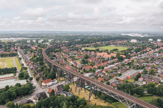 Aerial view on Rendsburg, Germany, with Rendsburger Hochbr&uuml;cke railway viaduct inclination loop (Neum&uuml;nster&ndash;Flensburg line) going through the city