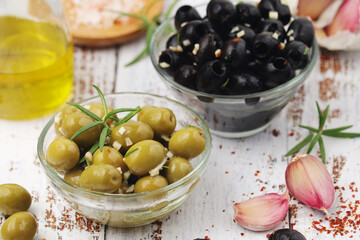Black and green olives in glass bowls