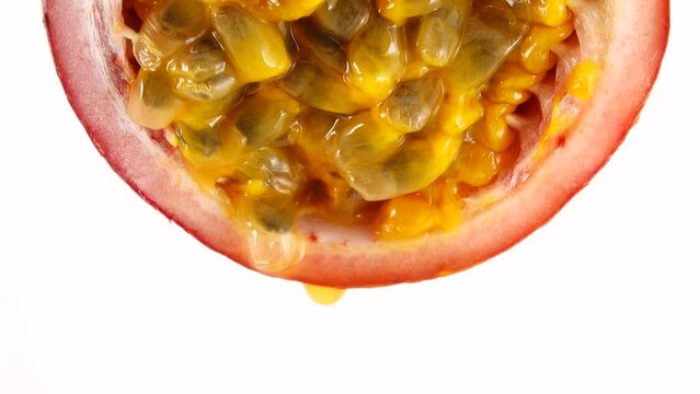 4K cross-section of a puple passion fruit Macro shot of sliced fresh exotic passion fruit fruit isolated on white background