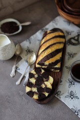 Striped biscuit roll with chocolate filling. Zebra pie with classic and chocolate biscuit.
