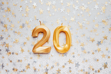 Number 20 twenty golden celebration birthday candle on Festive Background. twenty years birthday....