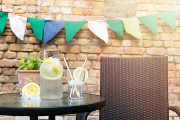 Water fresh and cold in a hot summer day with ice cubes and lemon. Heat dehydration concept. Placed...