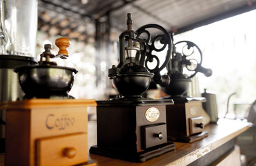 Old coffee grinder and coffee on cafe background