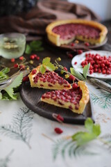 Two pieces of pie. Open almond tart with wild strawberries on a table with a tablecloth. Homemade cakes with hand-picked seasonal berries.
