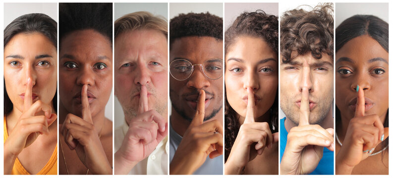 group of people with silence gesture