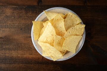 high angle view bowl of nacho chips on old wood table