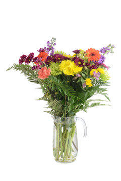 isolated vase of colorful assorted flowers on white background