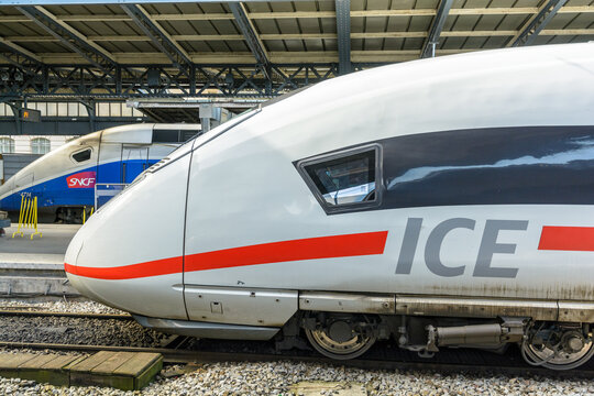 Paris, France - March 14, 2018: An ICE high speed train from german company Deutsche Bahn in Paris Gare de l'Est station with a TGV Duplex bullet train from french company SNCF in the background.