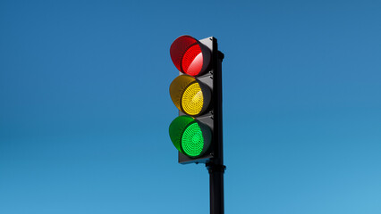 traffic light with red, yellow and green colors on isolated on blue sky background. Mock-up or...