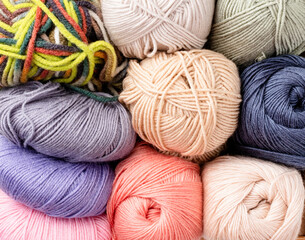 colorful yarn wool on shopfront. Knitting background, a lot of balls. Knitting yarn for handmade winter clothes