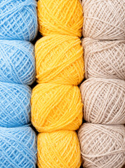 colorful yarn wool on shopfront. Knitting background, a lot of balls. Knitting yarn for handmade winter clothes