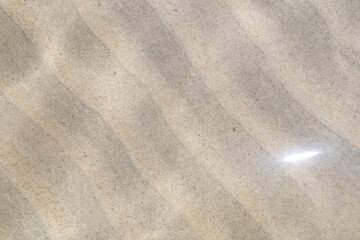 Shallow sea water surface with light reflection. Background