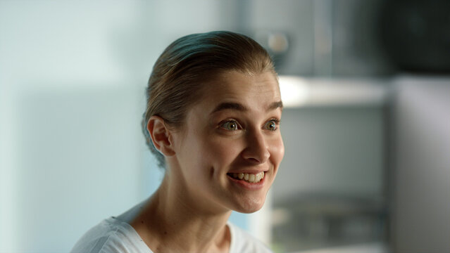 Pretty girl enjoy videocalling friend close up. Impressed woman getting news