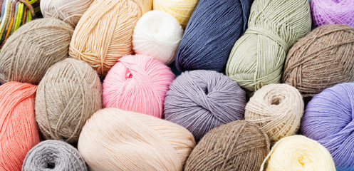 pastel colored yarn wool on shopfront. Knitting background, a lot of balls. Knitting yarn for...